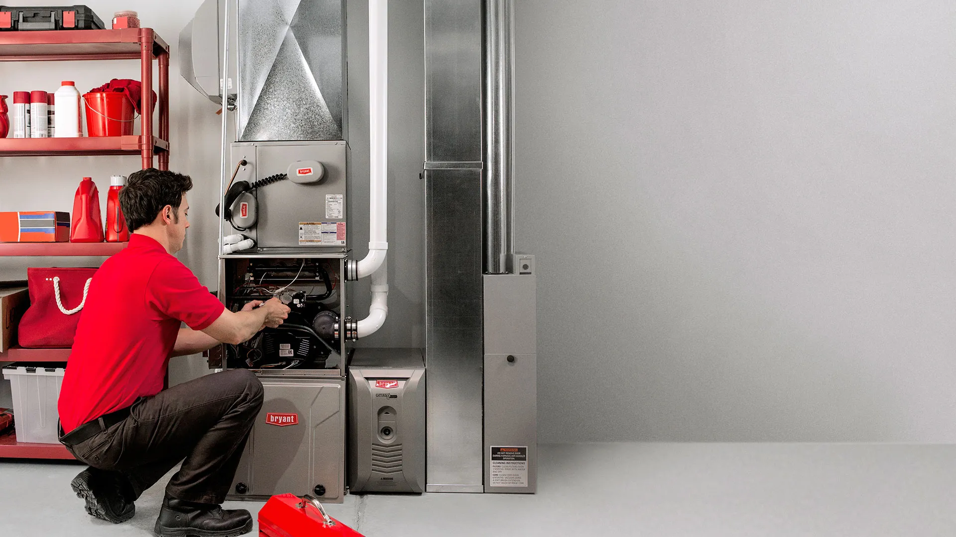 Technician performing maintenance on a home furnace system, illustrating furnace replacement cost considerations.